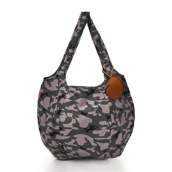 Man on the beach with a filled pacsac over his shoulder