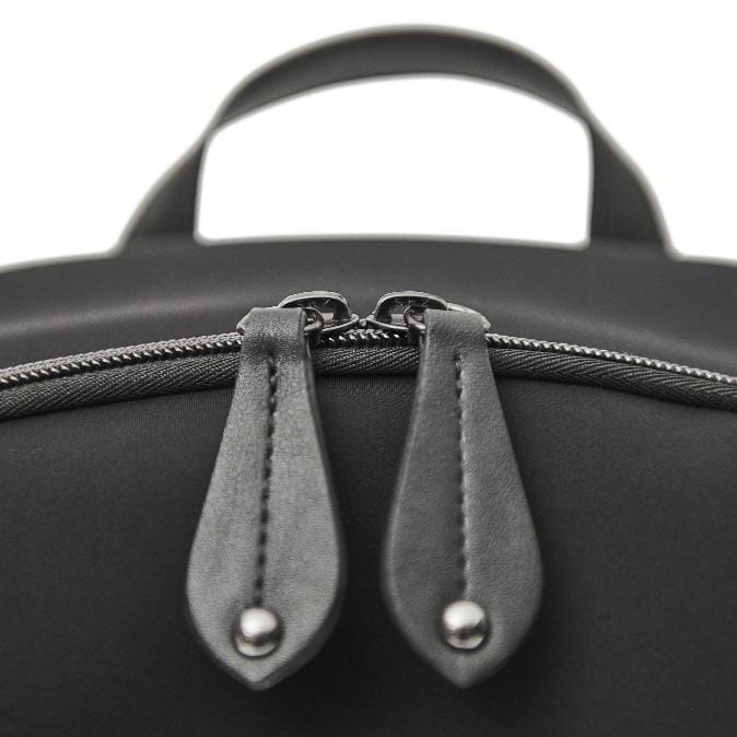 Details image of the top zip pulls in vegan leather
