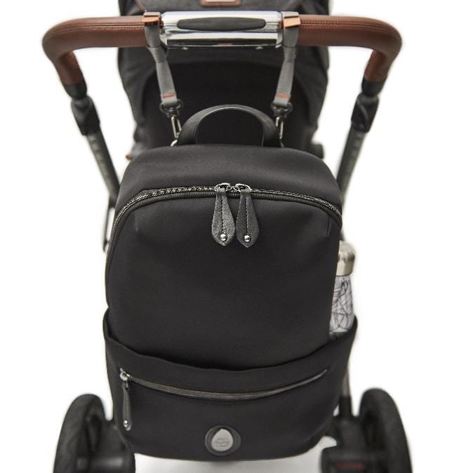 The Rockham changing bag hanging from the pram with the pram clips