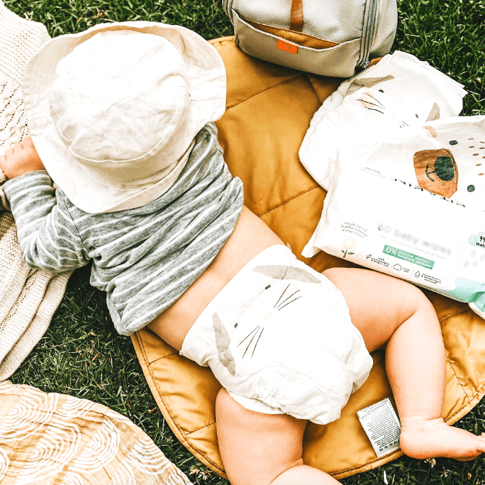 baby on changing mat in the park