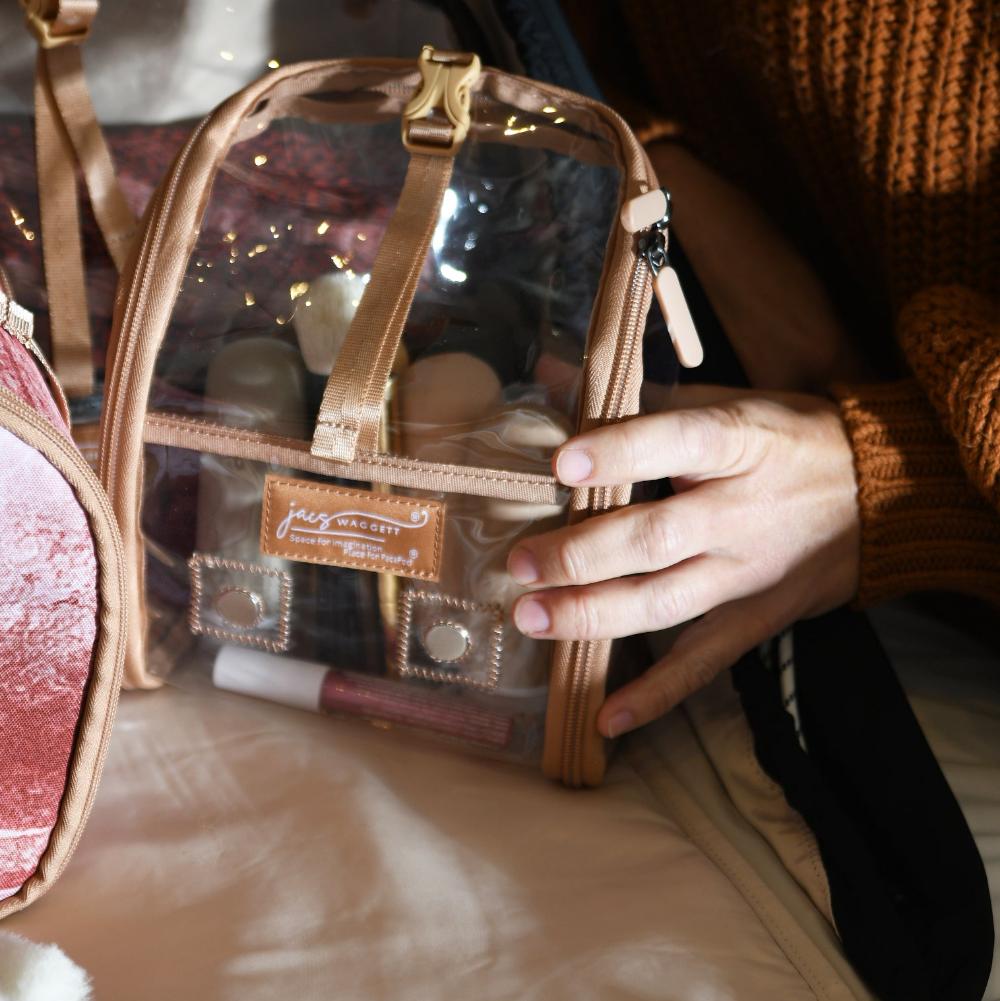 clear pod on bed with make up in