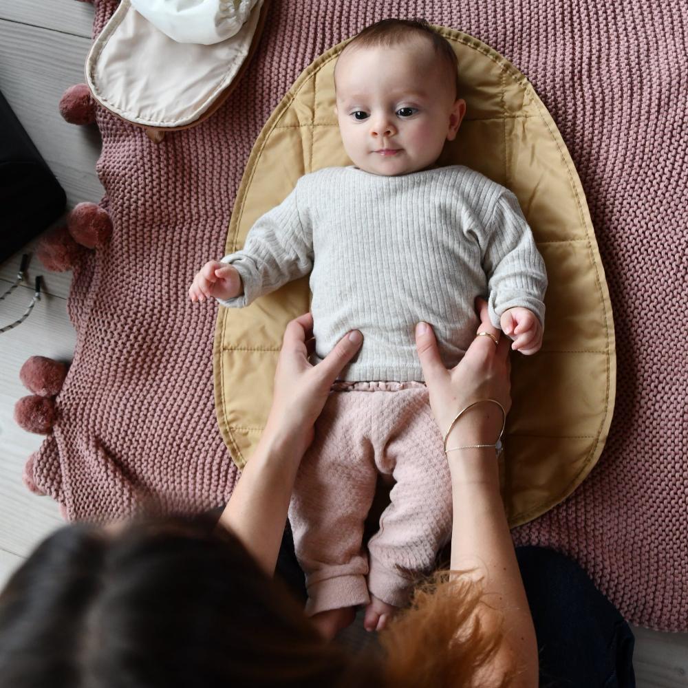 baby on changing mat