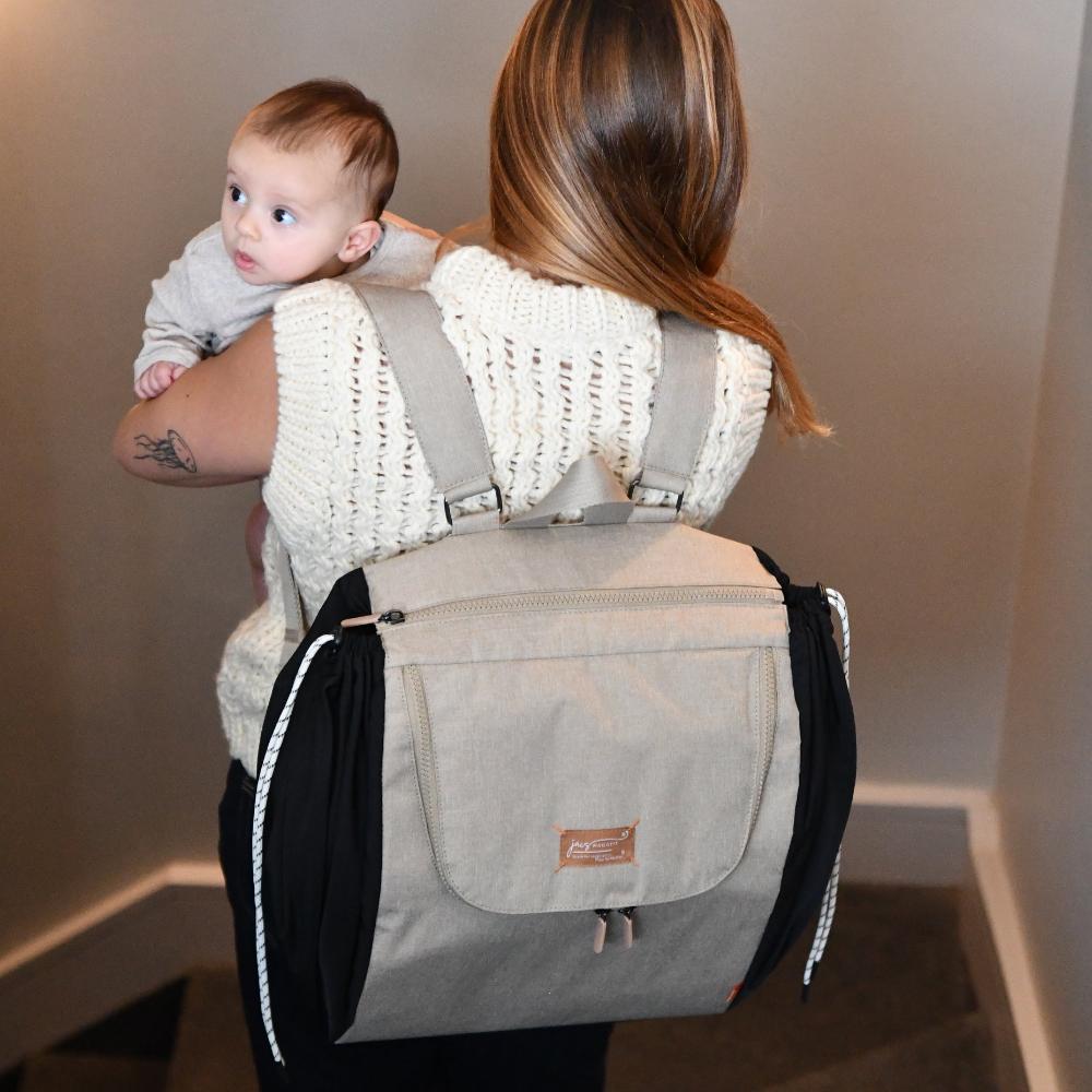 baby in arms with jacapod backpack sesame on shoulder