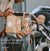 dad carrying baby and looking at baby in pram with pacapod bags handing from the pram handle
