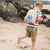 Boy playing on the beach with the badger toddler pod on his back