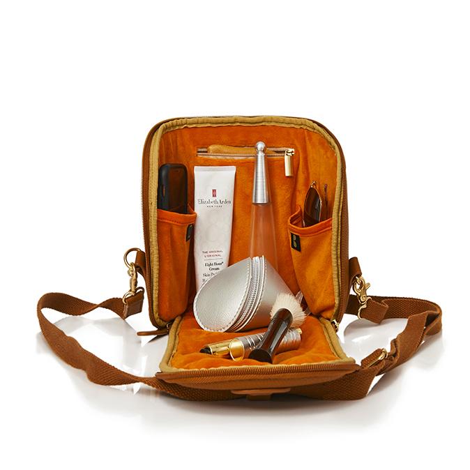 Open freedom pod showing the orange inner fabric with items inside as packing suggestions