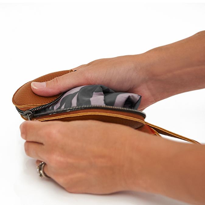 The pacsac being packed into the tan outer case