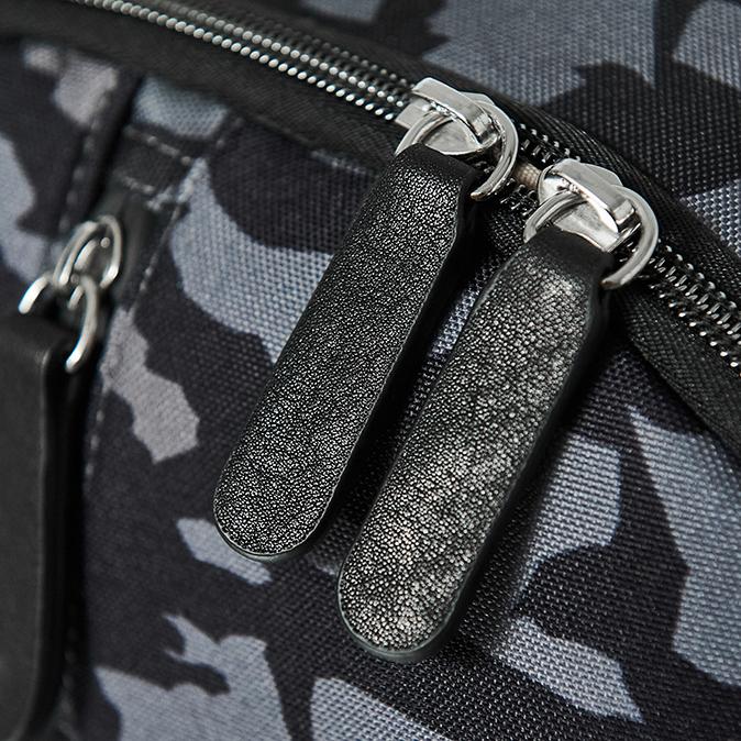 Detail image of the zip pulls on the backpack