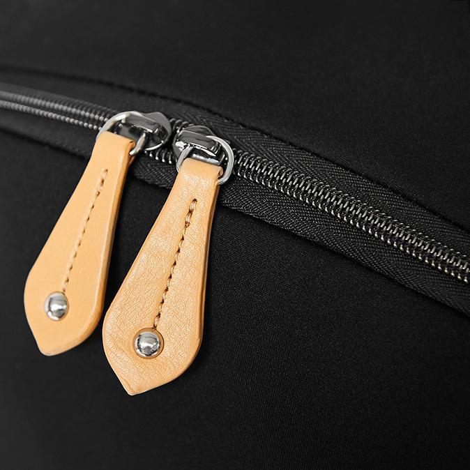 Details image of the top zip pulls in vegan leather 