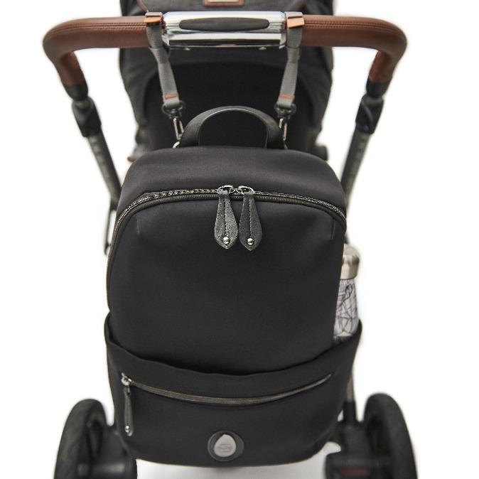 The Rockham changing bag hanging from the pram with the pram clips