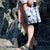 Woman stood on some rocks with the pacadry camo hanging from her wrist by her side