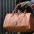 lady carrying vegan baby changing bag on her arm, colour oak in a tote style